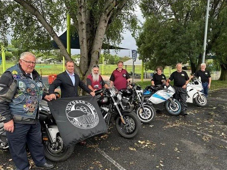 Ulysses Motorcycle Club Rally 1 a group of people standing next to motorcycles from the Ulysses Motorcycle Club Rally